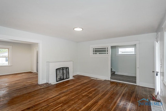 1385 Berdan Ave, Toledo, OH 43612 - unfurnished living room with wood-type flooring, plenty of natural light, stairs, and a fireplace