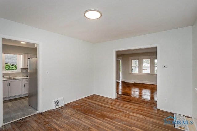 1385 Berdan Ave, Toledo, OH 43612 - spare room featuring hardwood / wood-style flooring, baseboards, and a sink