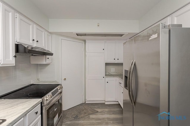 1385 Berdan Ave, Toledo, OH 43612 - kitchen featuring stainless steel range with electric stovetop, fridge with ice dispenser, under cabinet range hood, white cabinets, and light countertops