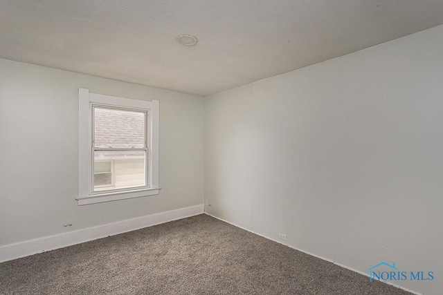 1385 Berdan Ave, Toledo, OH 43612 - spare room featuring dark carpet and baseboards