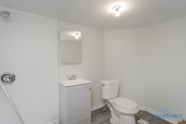 1385 Berdan Ave, Toledo, OH 43612 - half bathroom featuring wood finished floors, vanity, toilet, and baseboards