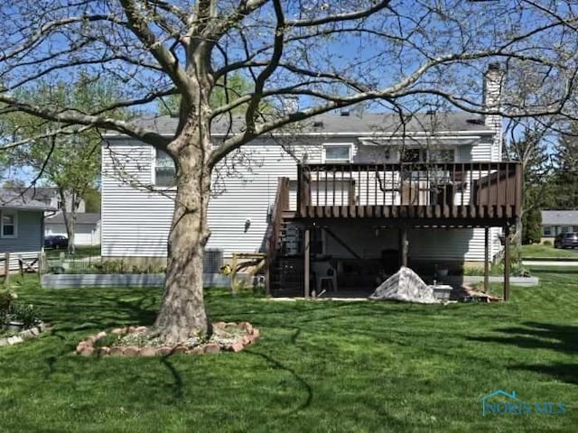 146 Partridge Ln, Perrysburg, OH 43551 - back of house featuring a wooden deck, a lawn, and a chimney