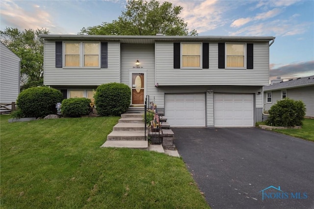 146 Partridge Ln, Perrysburg, OH 43551 - split foyer home with a garage, asphalt driveway, and a front yard