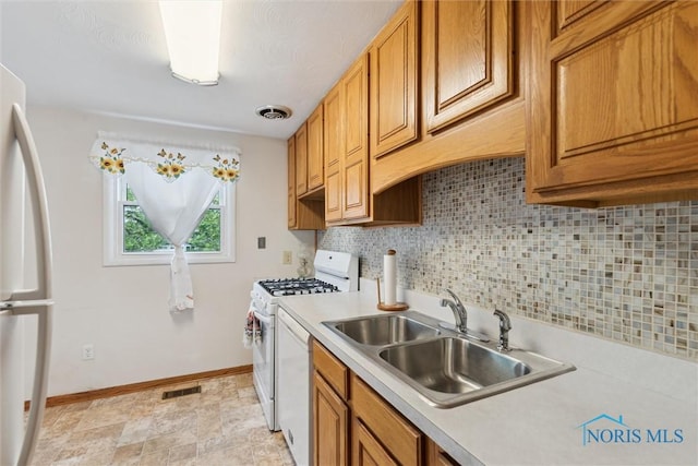 146 Partridge Ln, Perrysburg, OH 43551 - kitchen featuring white appliances, a sink, light countertops, baseboards, and decorative backsplash