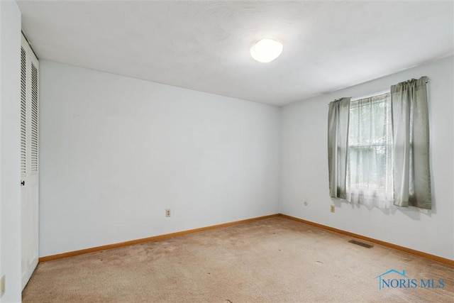 146 Partridge Ln, Perrysburg, OH 43551 - unfurnished bedroom with light carpet, baseboards, and a closet