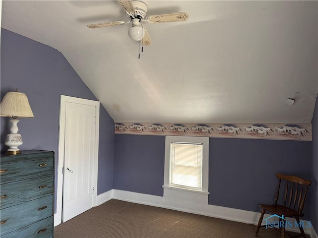 108 E Maple St, Deshler, OH 43516 - unfurnished bedroom with vaulted ceiling, dark carpet, baseboards, and ceiling fan