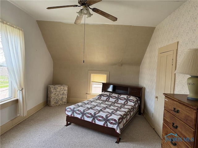 108 E Maple St, Deshler, OH 43516 - carpeted bedroom with multiple windows, vaulted ceiling, wallpapered walls, a ceiling fan, and baseboards