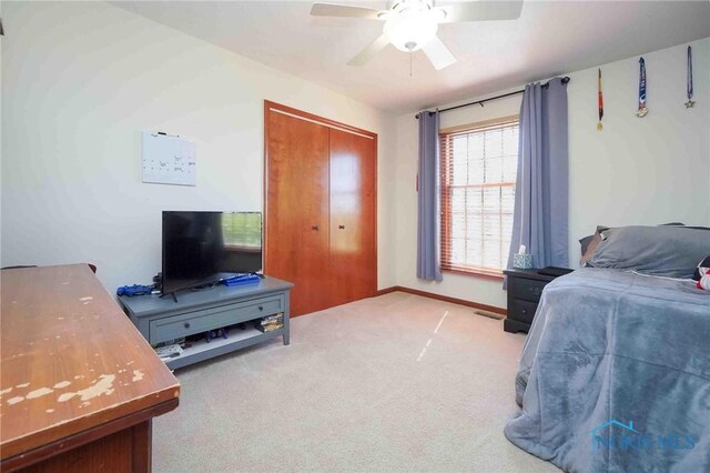16070 Rd S, Columbus Grove, OH 45830 - bedroom with light carpet, baseboards, a closet, and ceiling fan