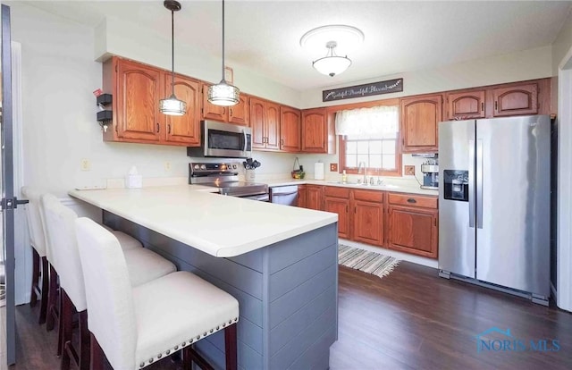 16070 Rd S, Columbus Grove, OH 45830 - kitchen with stainless steel appliances, a sink, a peninsula, light countertops, and dark wood-style flooring