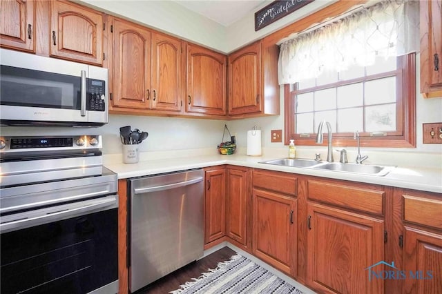 16070 Rd S, Columbus Grove, OH 45830 - kitchen with appliances with stainless steel finishes, a sink, brown cabinets, and light countertops