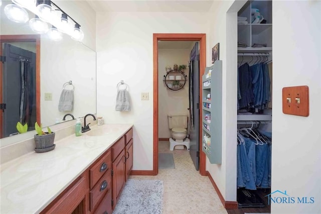 16070 Rd S, Columbus Grove, OH 45830 - full bathroom with vanity, toilet, a spacious closet, and baseboards