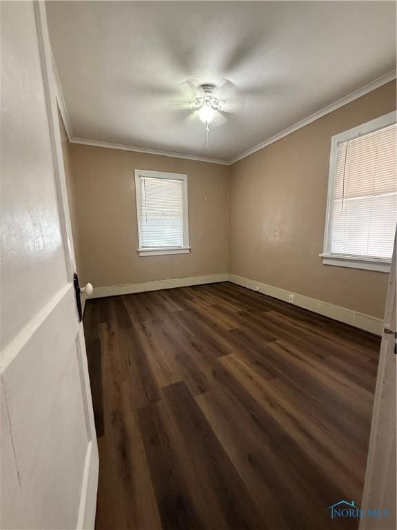 1726 Balkan Pl, Toledo, OH 43613 - unfurnished room featuring crown molding, baseboards, dark wood-style flooring, and a ceiling fan