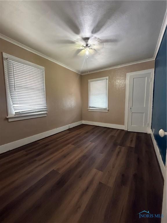 1726 Balkan Pl, Toledo, OH 43613 - spare room featuring dark wood-style floors, baseboards, crown molding, and a ceiling fan