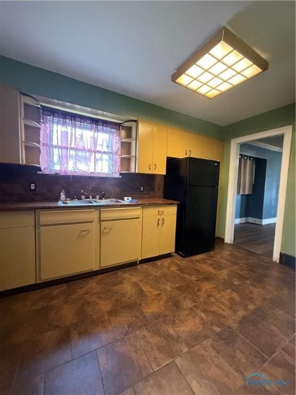 1726 Balkan Pl, Toledo, OH 43613 - kitchen featuring freestanding refrigerator, open shelves, decorative backsplash, a sink, and cream cabinetry