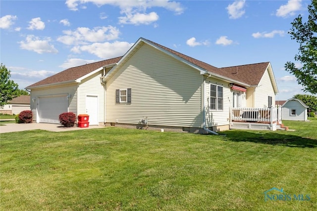 1250 Indiana Ave, Napoleon, OH 43545 - view of home's exterior featuring an attached garage, driveway, a yard, a deck, and roof with shingles