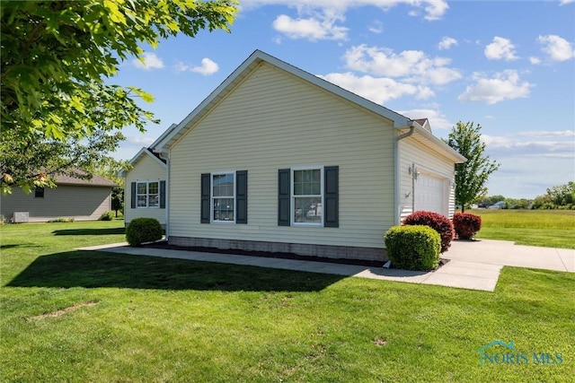 1250 Indiana Ave, Napoleon, OH 43545 - view of property exterior featuring a garage and a yard