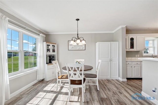 1250 Indiana Ave, Napoleon, OH 43545 - dining room with a chandelier, light wood-style floors, baseboards, and ornamental molding
