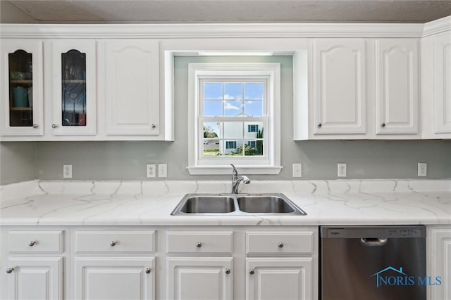 1250 Indiana Ave, Napoleon, OH 43545 - kitchen featuring stainless steel dishwasher, a sink, white cabinets, and glass insert cabinets
