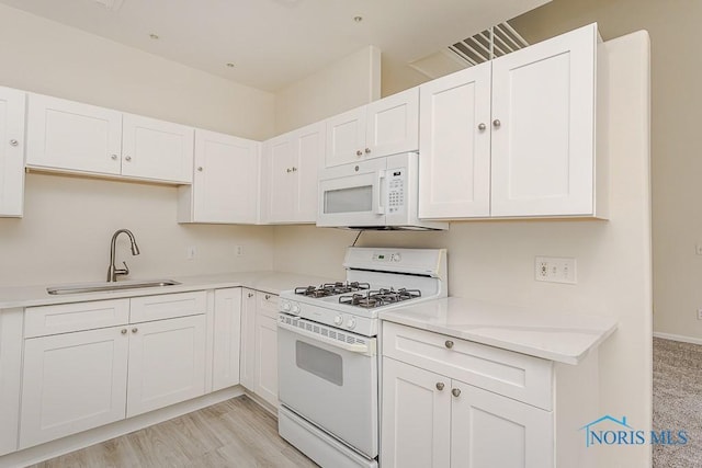 4022 Stonehenge Dr Unit 4022, Sylvania, OH 43560 - kitchen with white appliances, a sink, light countertops, and white cabinets