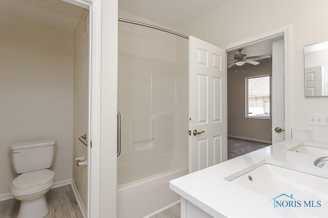 4022 Stonehenge Dr Unit 4022, Sylvania, OH 43560 - full bathroom featuring a ceiling fan, vanity, toilet, shower / bath combination, and wood finished floors