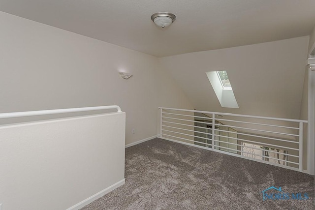 4022 Stonehenge Dr Unit 4022, Sylvania, OH 43560 - hall with a skylight, an upstairs landing, carpet flooring, lofted ceiling, and baseboards