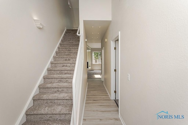 4022 Stonehenge Dr Unit 4022, Sylvania, OH 43560 - stairway featuring baseboards, wood finished floors, and recessed lighting