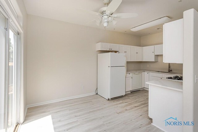 4022 Stonehenge Dr Unit 4022, Sylvania, OH 43560 - kitchen with white appliances, light wood-type flooring, a sink, a ceiling fan, and light countertops