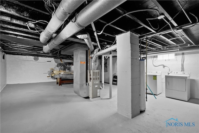 1006 Woodward Ave, Toledo, OH 43608 - basement featuring washer and clothes dryer, heating unit, and water heater