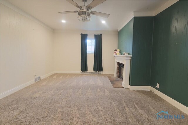 1006 Woodward Ave, Toledo, OH 43608 - unfurnished living room featuring ceiling fan, ornamental molding, light carpet, a fireplace, and baseboards