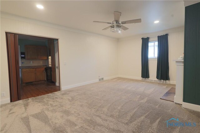 1006 Woodward Ave, Toledo, OH 43608 - empty room with dark carpet, ceiling fan, crown molding, recessed lighting, and baseboards