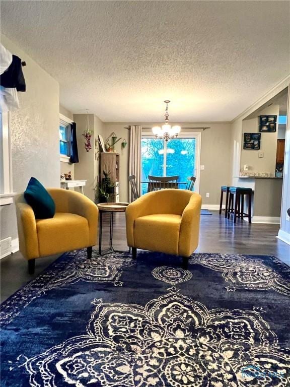 5806 Elmer Dr, Toledo, OH 43615 - living area with a chandelier, a textured ceiling, and baseboards
