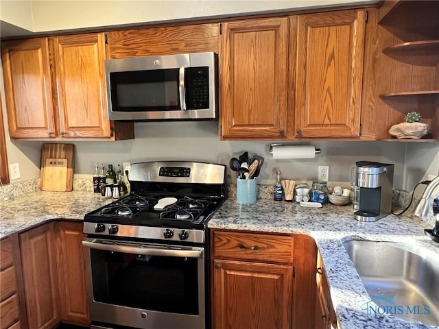 5806 Elmer Dr, Toledo, OH 43615 - kitchen featuring appliances with stainless steel finishes, a sink, open shelves, and brown cabinets