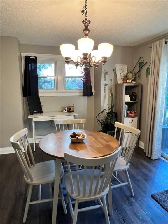 5806 Elmer Dr, Toledo, OH 43615 - dining area featuring a textured ceiling, dark wood-type flooring, a chandelier, and baseboards