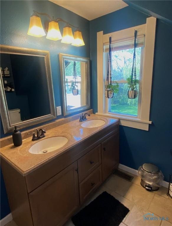 5806 Elmer Dr, Toledo, OH 43615 - bathroom featuring double vanity, baseboards, and tile patterned floors