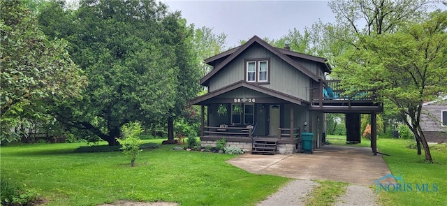 5806 Elmer Dr, Toledo, OH 43615 - view of front of house featuring a porch, driveway, a front lawn, and a chimney