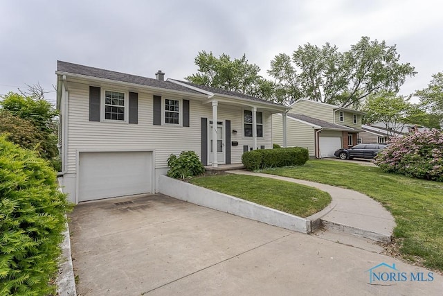 1201 Birch Ave, Maumee, OH 43537 - split foyer home with a front lawn, a garage, and driveway