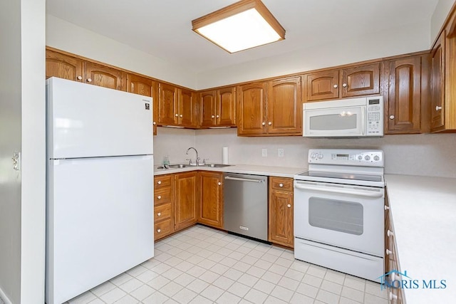 1201 Birch Ave, Maumee, OH 43537 - kitchen featuring white appliances, a sink, light countertops, and brown cabinetry