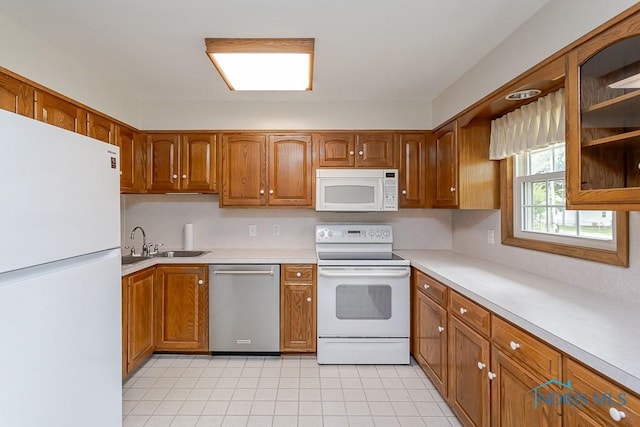 1201 Birch Ave, Maumee, OH 43537 - kitchen featuring white appliances, brown cabinetry, a sink, and light countertops