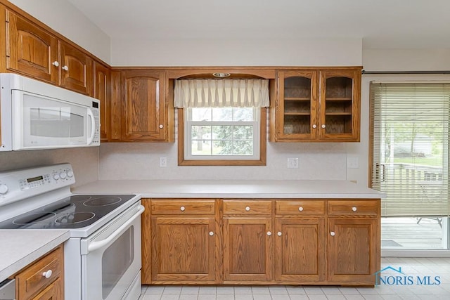 1201 Birch Ave, Maumee, OH 43537 - kitchen featuring white appliances, light countertops, and glass insert cabinets