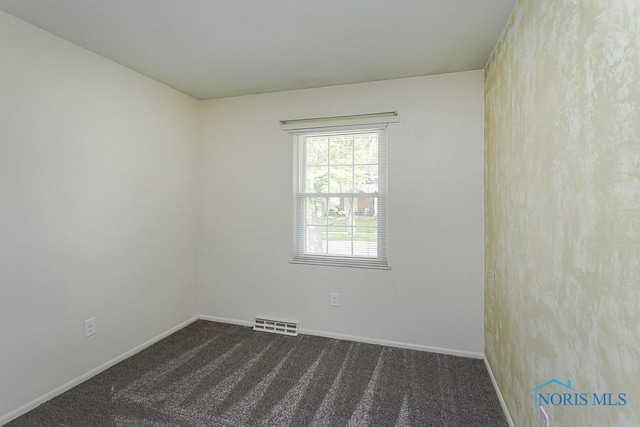 1201 Birch Ave, Maumee, OH 43537 - empty room featuring dark carpet and baseboards