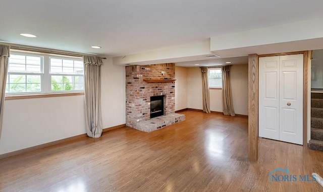 1201 Birch Ave, Maumee, OH 43537 - unfurnished living room with baseboards, a brick fireplace, wood finished floors, and recessed lighting