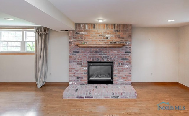 1201 Birch Ave, Maumee, OH 43537 - unfurnished living room with wood finished floors, baseboards, a brick fireplace, and recessed lighting