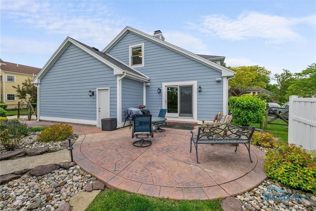 26741 Green Ville Dr, Perrysburg, OH 43551 - back of house featuring a patio and a chimney
