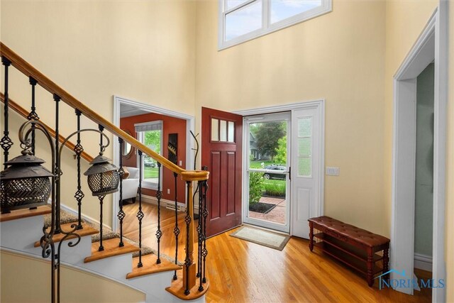 26741 Green Ville Dr, Perrysburg, OH 43551 - foyer entrance featuring plenty of natural light, wood finished floors, stairs, and a high ceiling