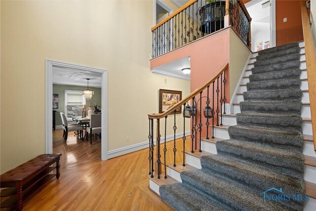 26741 Green Ville Dr, Perrysburg, OH 43551 - stairway featuring wood finished floors, baseboards, and a high ceiling