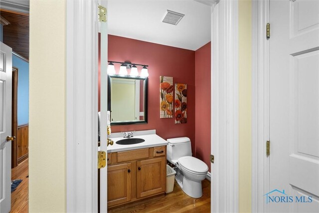 26741 Green Ville Dr, Perrysburg, OH 43551 - half bath with wood finished floors, toilet, and vanity