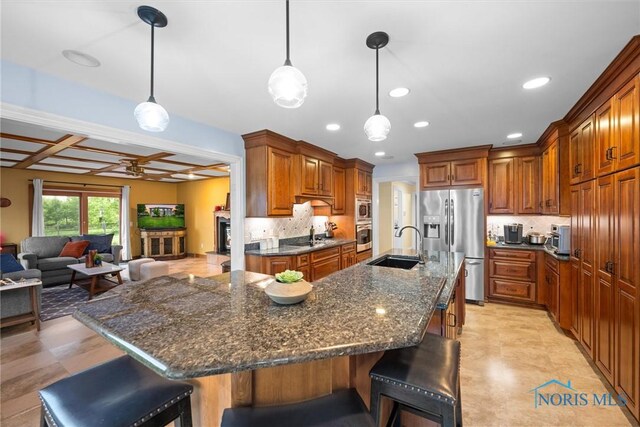 26741 Green Ville Dr, Perrysburg, OH 43551 - kitchen featuring stainless steel appliances, a sink, a breakfast bar area, coffered ceiling, and recessed lighting