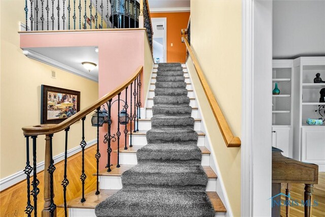 26741 Green Ville Dr, Perrysburg, OH 43551 - staircase featuring ornamental molding, wood finished floors, and baseboards
