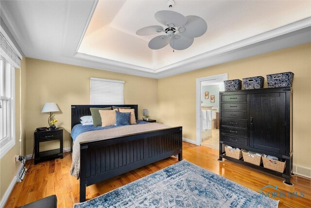 26741 Green Ville Dr, Perrysburg, OH 43551 - bedroom featuring a raised ceiling, baseboards, wood finished floors, and ceiling fan