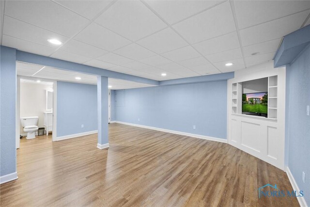 26741 Green Ville Dr, Perrysburg, OH 43551 - finished basement featuring built in features, wood finished floors, baseboards, a paneled ceiling, and recessed lighting